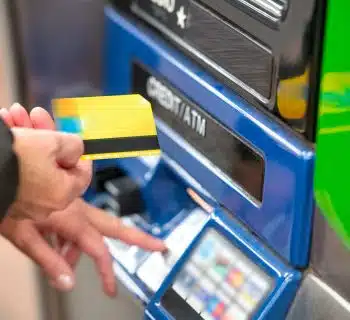 a person using a credit card to pay for a machine